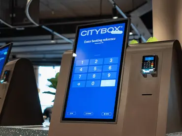 Close-up of Citybox self check-in kiosk with Beetronics touchscreen and card reader.